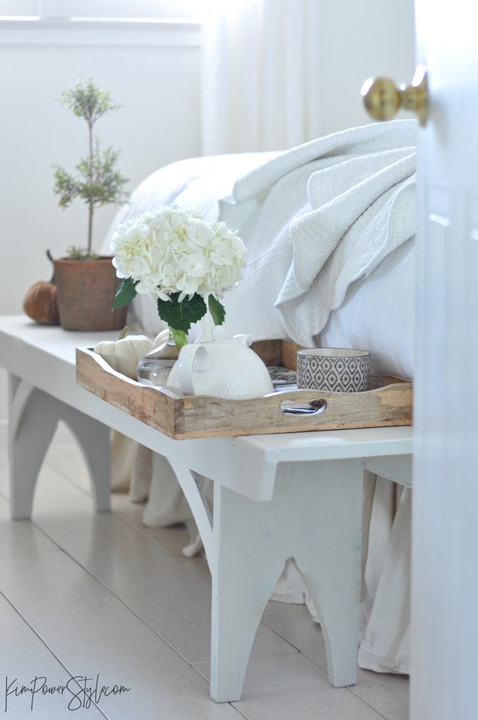 A wooden tray with a pot of tea and a few little fall touches