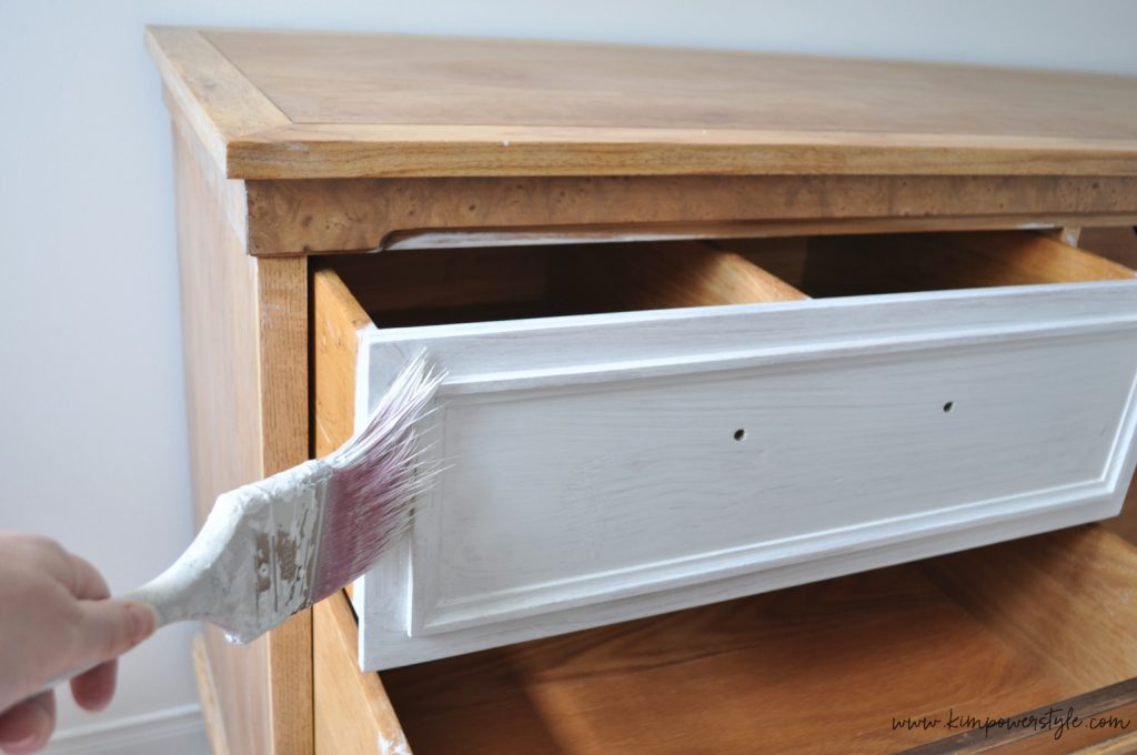 white washing the dresser for guest room makeover.